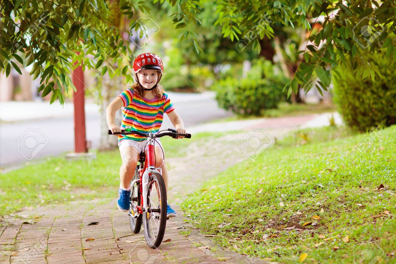 Kids On Bike In Park Children Going To School Wearing Safe Bicycle Stock Photo Picture And Royalty Free Image Image