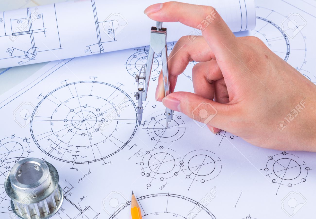 mans hand with a compass mechanical engineer at work technical mechanical engineer picture
