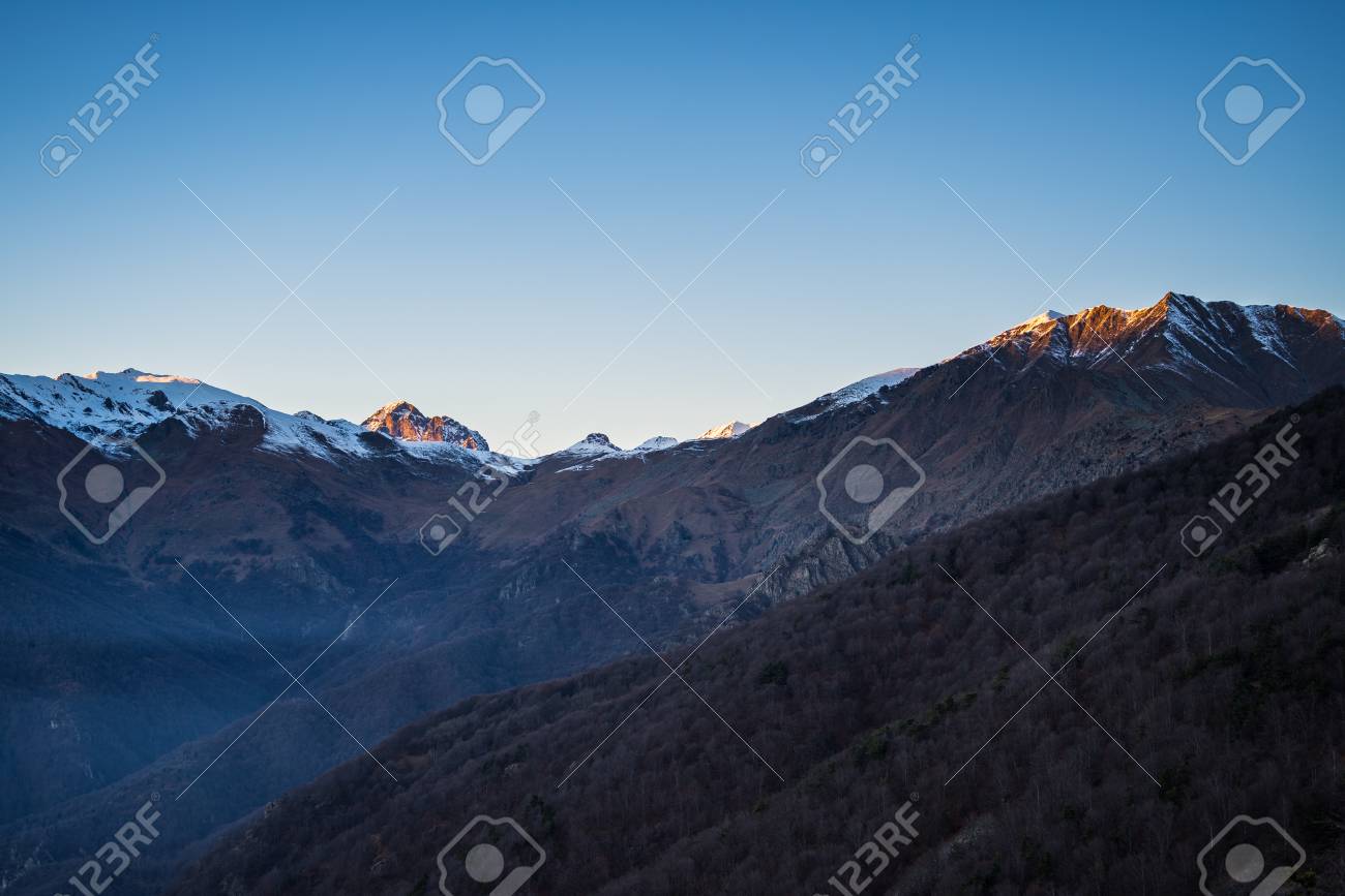 Last Sunlight On The Alpine Arc With Glowing Peaks Arising From The Misty Valley Below Last Sunlight On The Alpine Arc With Glowing Peaks Arising From The Misty Valley Below
