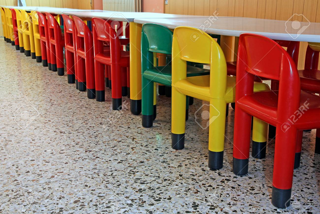 long line of colored plastic chairs in the refectory of the nursery