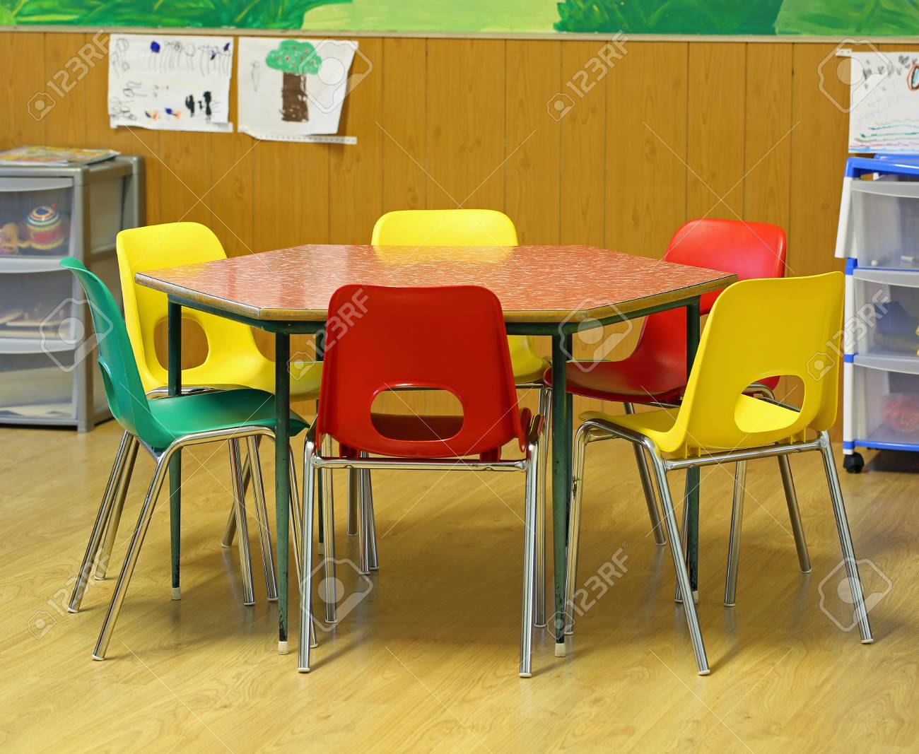 hexagonal table with small chairs in elementary school with parquet