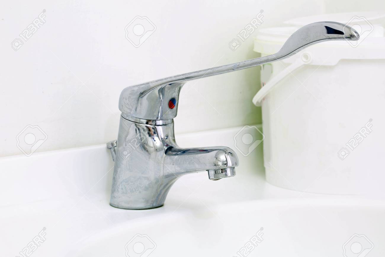 Stainless Steel Faucet Sink stainless steel faucet in a medical clinic with white sink stock photo 78112350