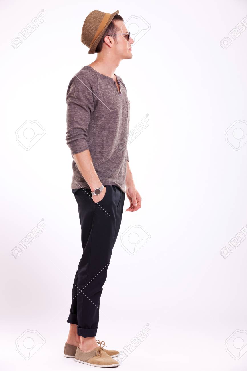 Side View Of A Relaxed Young Casual Man Holding A Hand In His Pocket And  Looking Away From The Camera, On A Light Background Stock Photo, Picture  and Royalty Free Image. Image