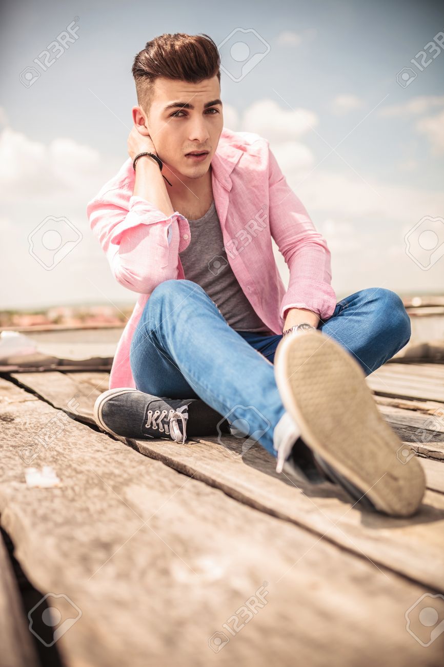 若い男が彼の深刻な座りポーズで彼の頭の背面を持って の写真素材 画像素材 Image