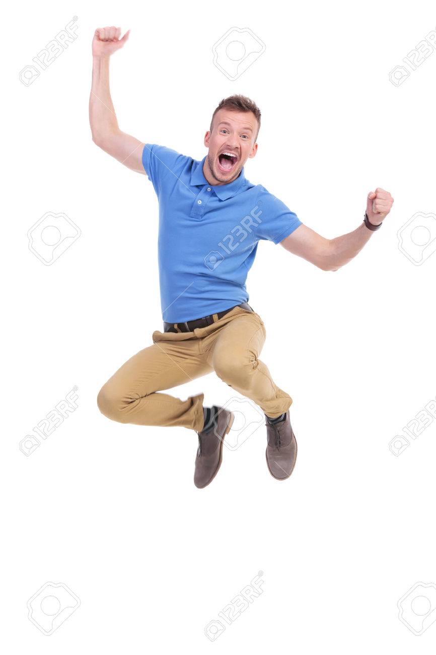 casual young man cheering while jumping in the air. isolated on white - 33450967