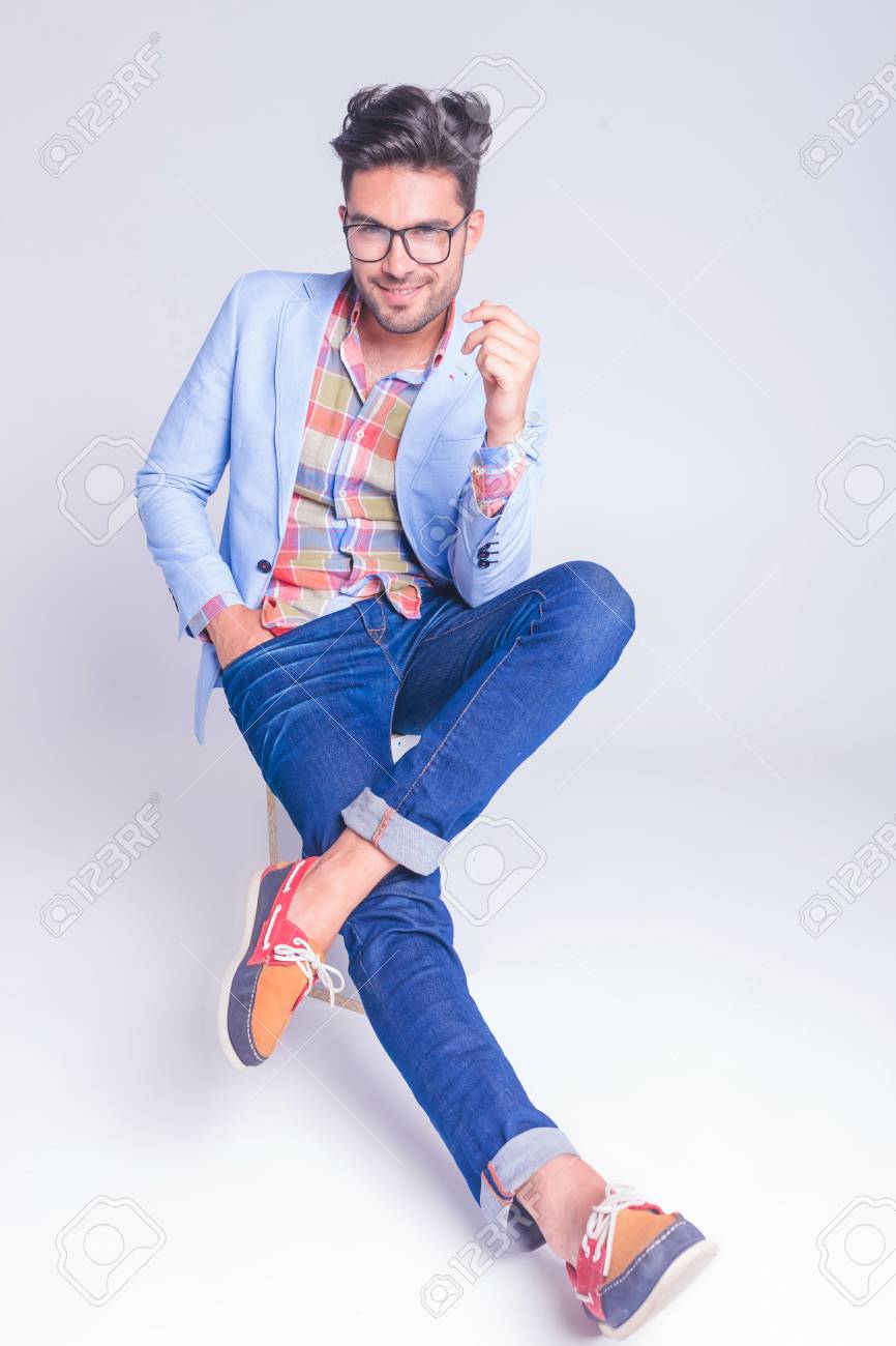 Handsome Casual Man Posing Seated With Legs Crossed And Hand In Pocket While Looking At The Camera In Studio Background Stock Photo Picture And Royalty Free Image Image Handsome Casual Man Posing Seated With Legs Crossed And Hand In Pocket While Looking At The Camera In Studio Background Stock Photo Picture And Royalty Free Image Image