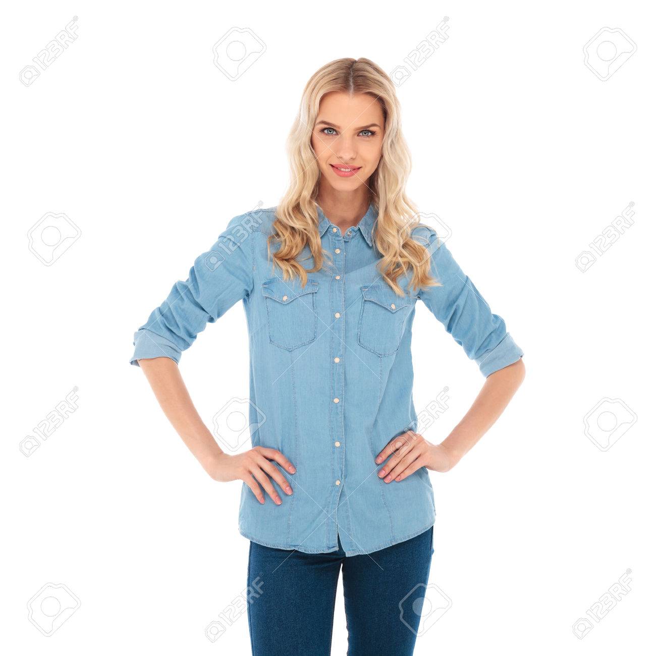 smiling blonde woman standing with hands on waist on white background - 64558600 smiling blonde woman standing with hands on waist on white background - 64558600