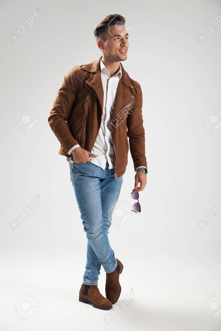Relaxed Laughing Casual Man Standing In Studio With Hand In Pocket And  Looks To Side Stock Photo, Picture And Royalty Free Image. Image 93950686.