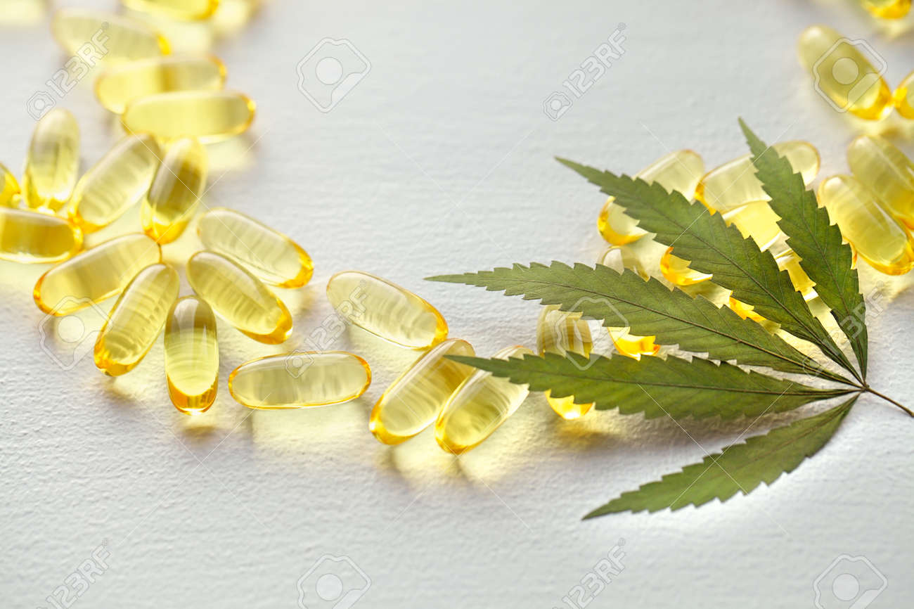 Medical cannabis products, leaf, capsules and CBD oil on white background. Pharmaceutical gelatin softgels with biological plant herbal. Organic dietary supplements concept - 169732004 Medical cannabis products, leaf, capsules and CBD oil on white background. Pharmaceutical gelatin softgels with biological plant herbal. Organic dietary supplements concept - 169732004