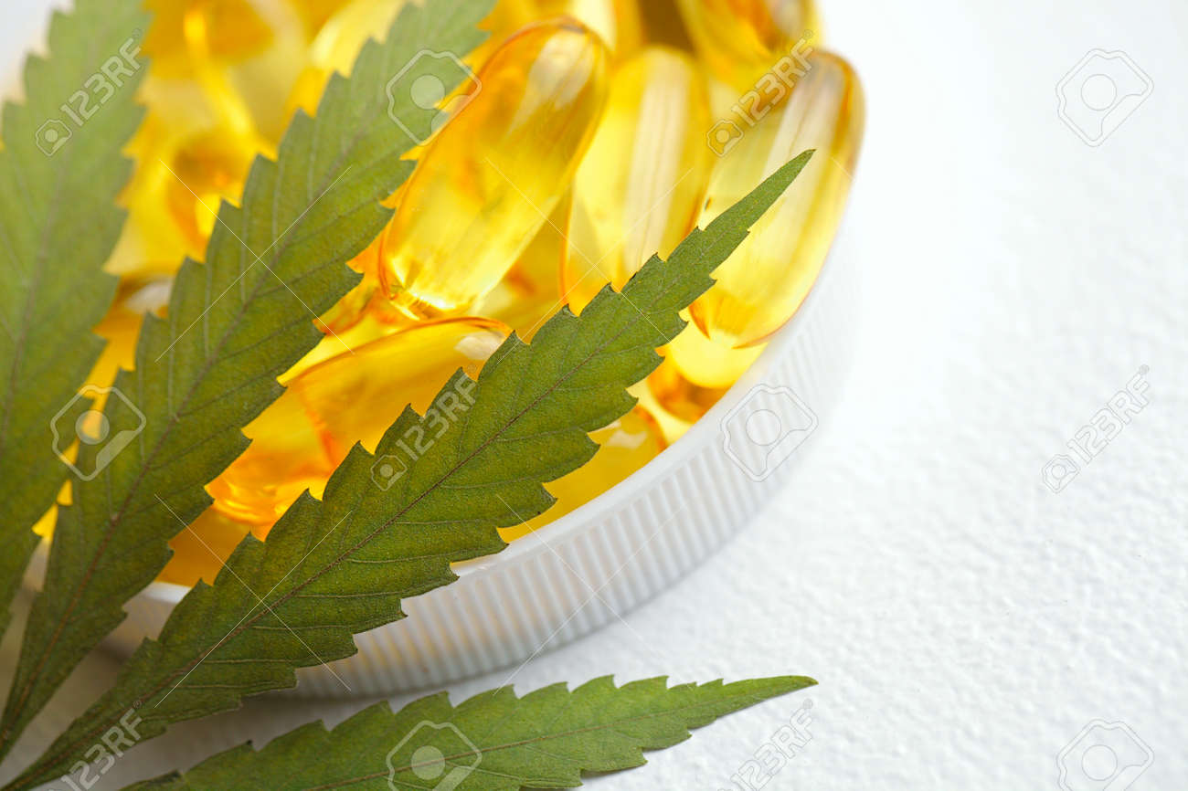 Cannabis CBD capsules are a medical cannabis product with leaves, CBD hemp oil capsules, on white background with copy space - 169732306 Cannabis CBD capsules are a medical cannabis product with leaves, CBD hemp oil capsules, on white background with copy space - 169732306