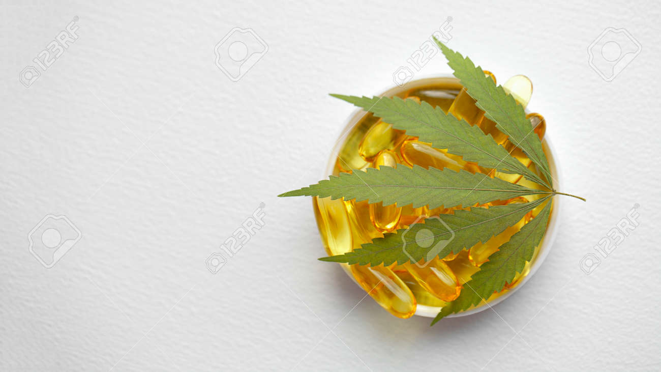 Cannabis CBD capsules are a medical cannabis product with leaves, CBD hemp oil capsules, on white background with copy space - 169732235 Cannabis CBD capsules are a medical cannabis product with leaves, CBD hemp oil capsules, on white background with copy space - 169732235