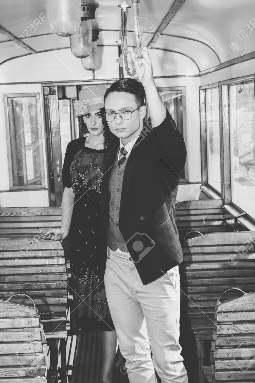 Vintage Retro Fashion Photo Old Time Modern Man With Glasses In Suit A Wagon Train Woman Behind Vintage Retro Fashion Photo Old Time Modern Man With Glasses In Suit A Wagon Train Woman Behind