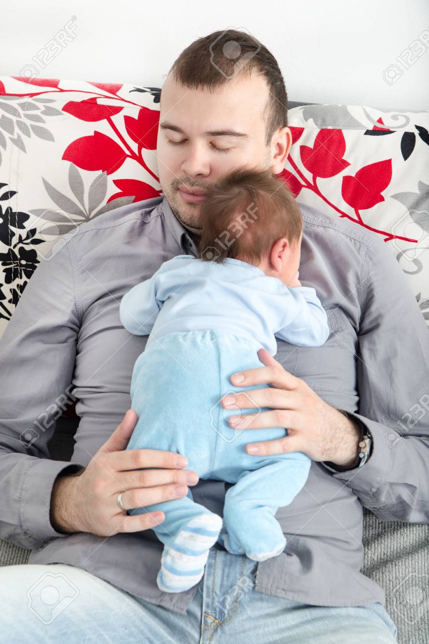 Young Father And His Little Baby Boy Together Papa With His Cheerful Newborn On Sofa Taking Good Time Stock Photo Picture And Royalty Free Image Image