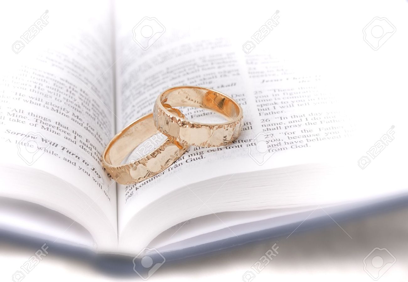 gold wedding rings on a bible stock photo picture and royalty free
