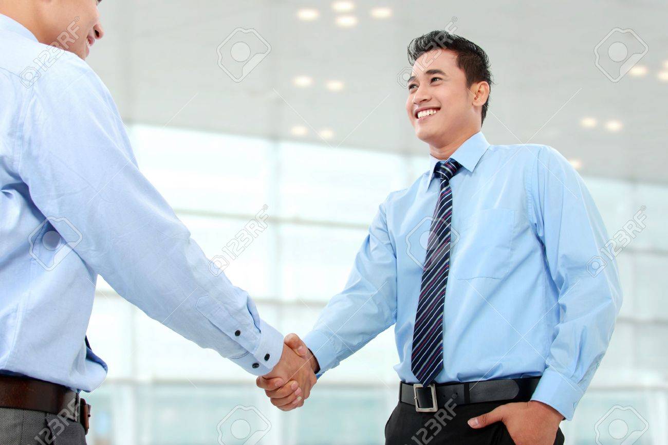 portrait of successful business man shaking hands with eachother