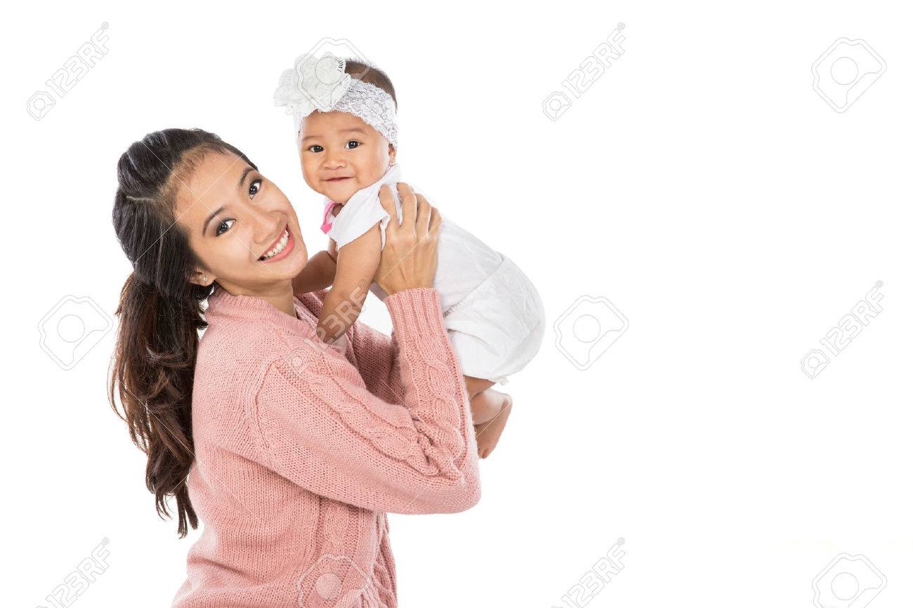 Asian woman holding her baby girl isolated over white background - 53046124 Asian woman holding her baby girl isolated over white background - 53046124