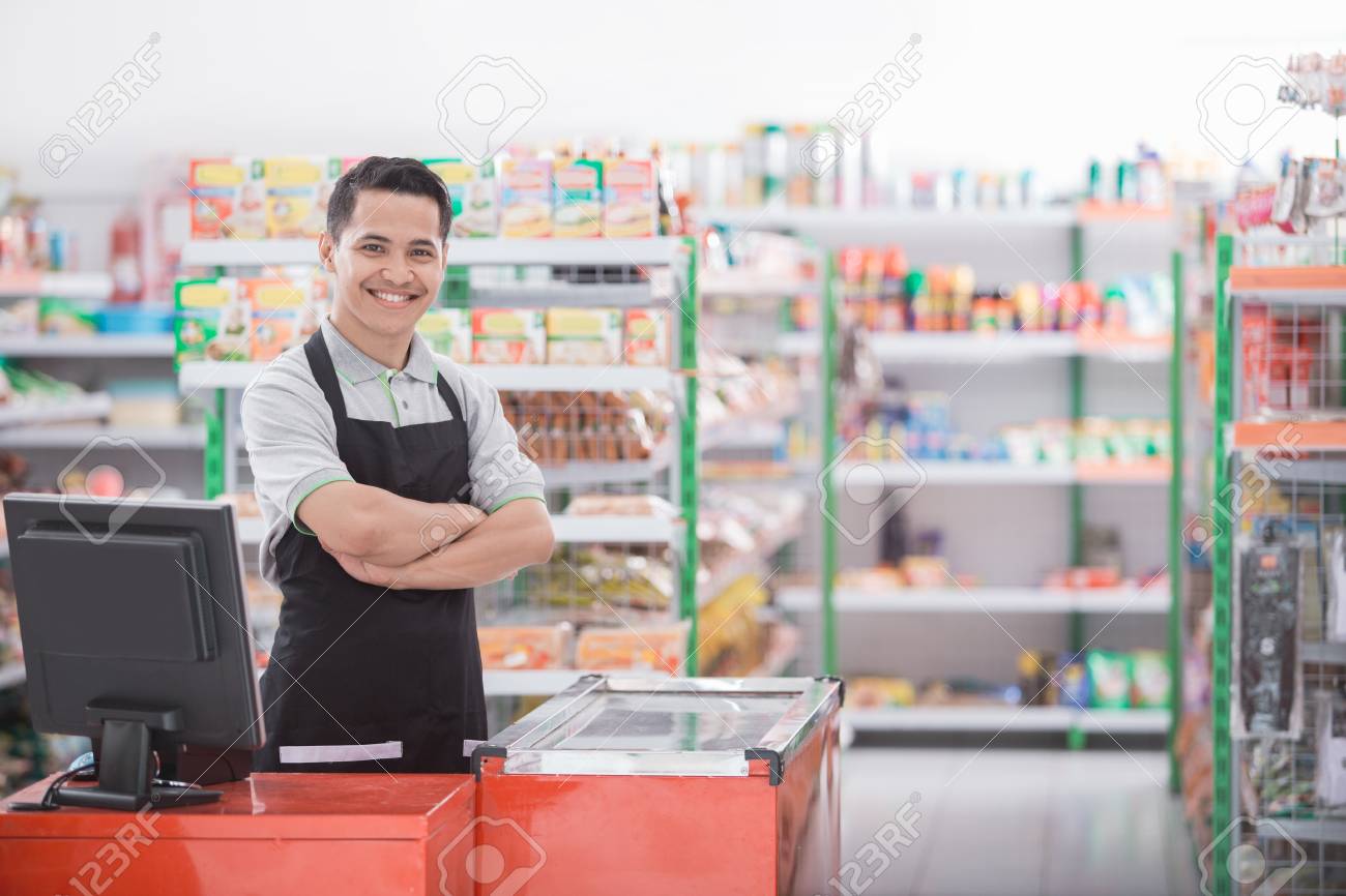 Portrait of a smiling shopkeeper in a grocery store - 89455314 Portrait of a smiling shopkeeper in a grocery store - 89455314