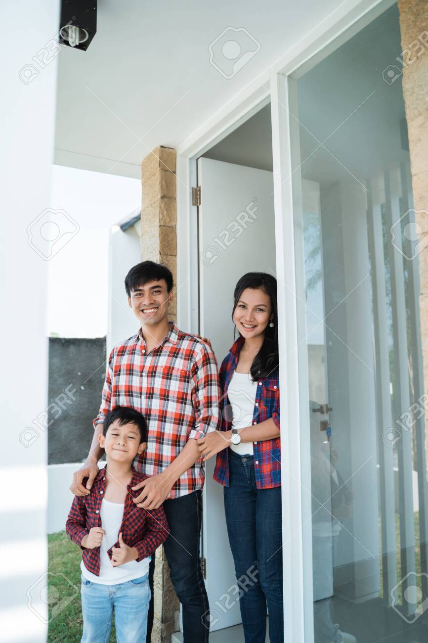 asian family in front of the door of their house - 121438033 asian family in front of the door of their house - 121438033