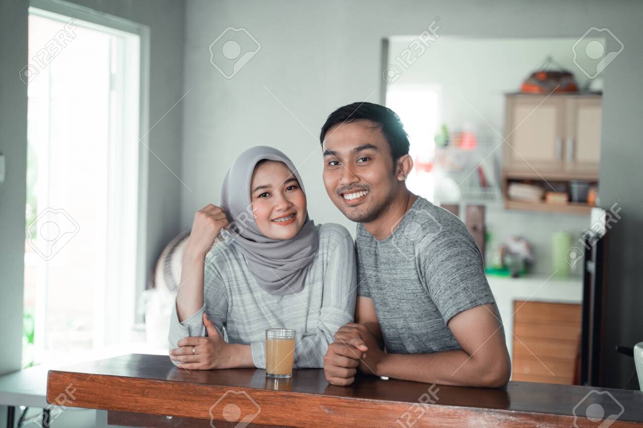 moslem couple relax sitting in the kitchen - 127048921 moslem couple relax sitting in the kitchen - 127048921