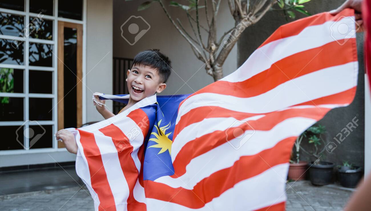Malaysian kid with flag running - 128600747 Malaysian kid with flag running - 128600747
