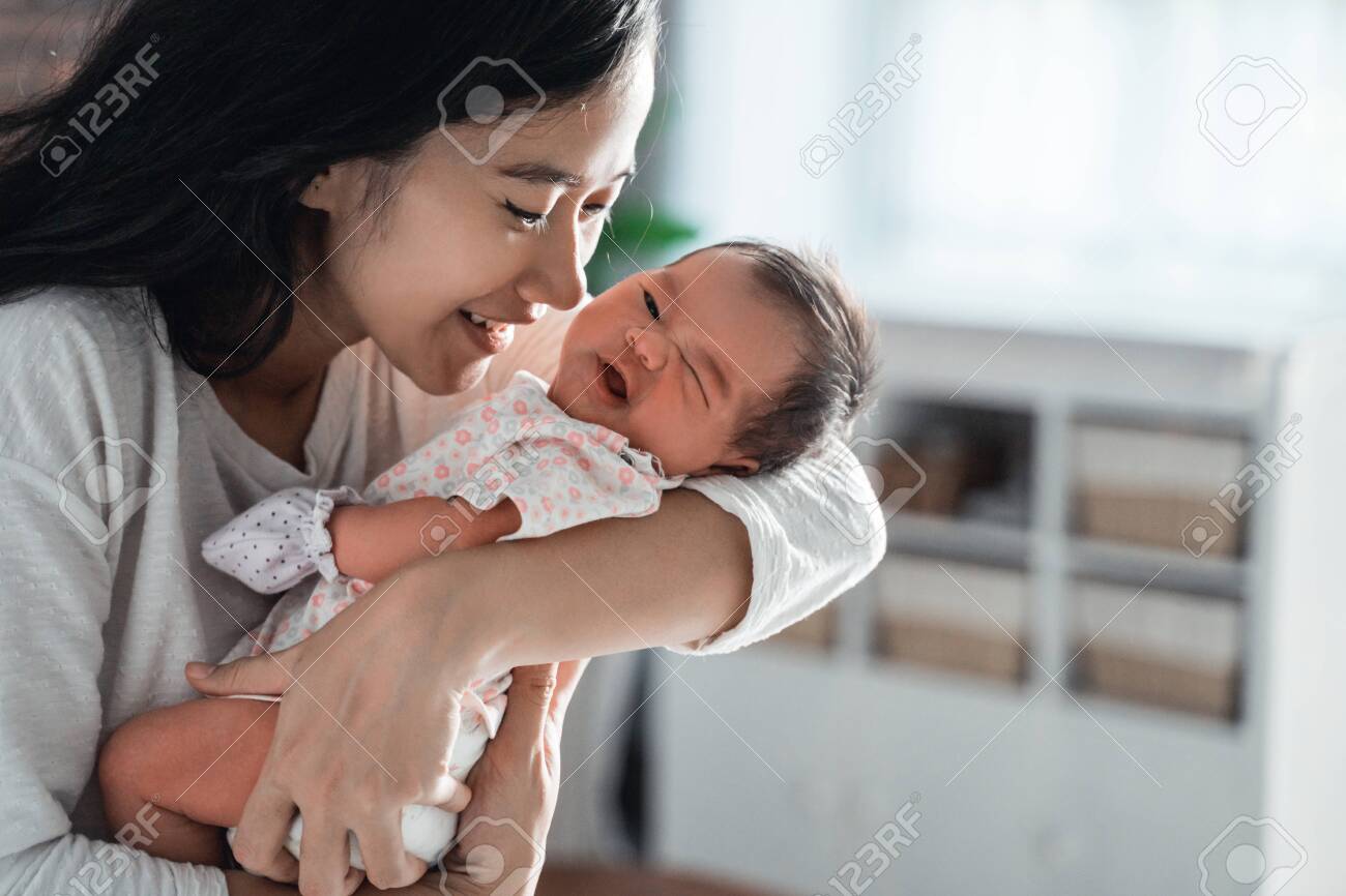 mother kissing her little daughter - 129696497 mother kissing her little daughter - 129696497