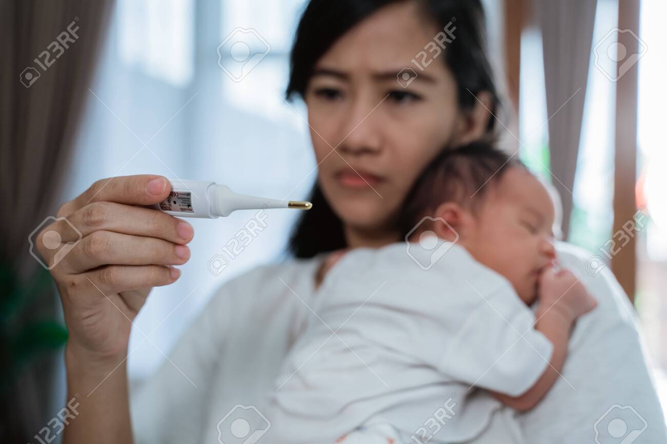 asian mother using thermometer feel worried about their childrens health - 130037268 asian mother using thermometer feel worried about their childrens health - 130037268