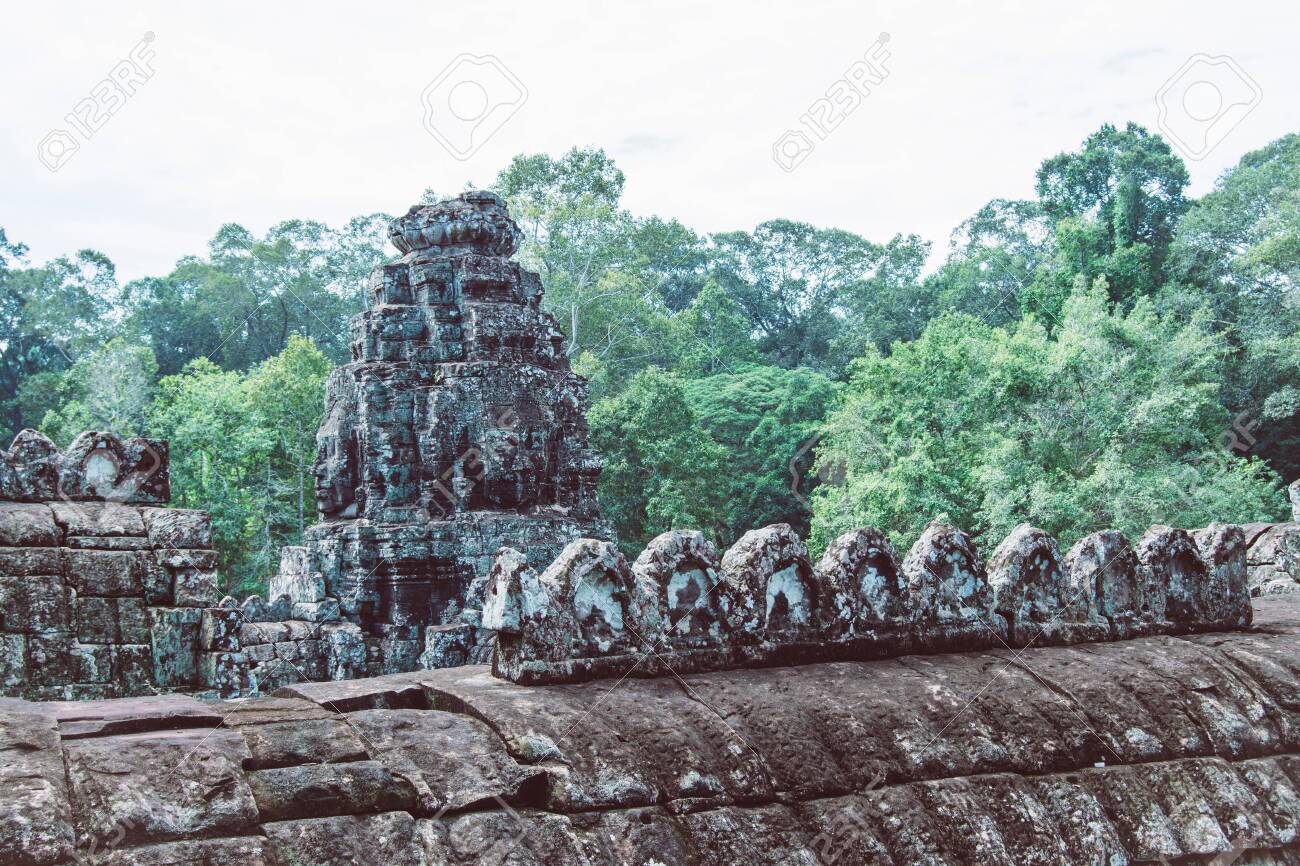 Sculptures made in rustic rocks on the roofs of the ruins of the Bayon temple in Ankgor Thom, Cambodia - World Heritage by UNESCO in 1992 - Colorful Photo - 128724072 Sculptures made in rustic rocks on the roofs of the ruins of the Bayon temple in Ankgor Thom, Cambodia - World Heritage by UNESCO in 1992 - Colorful Photo - 128724072