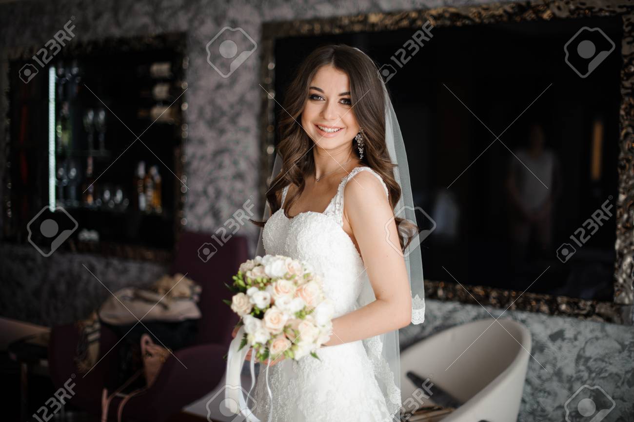 Portrait Of A Happy Brunette Bride With Simple Hairstyle And