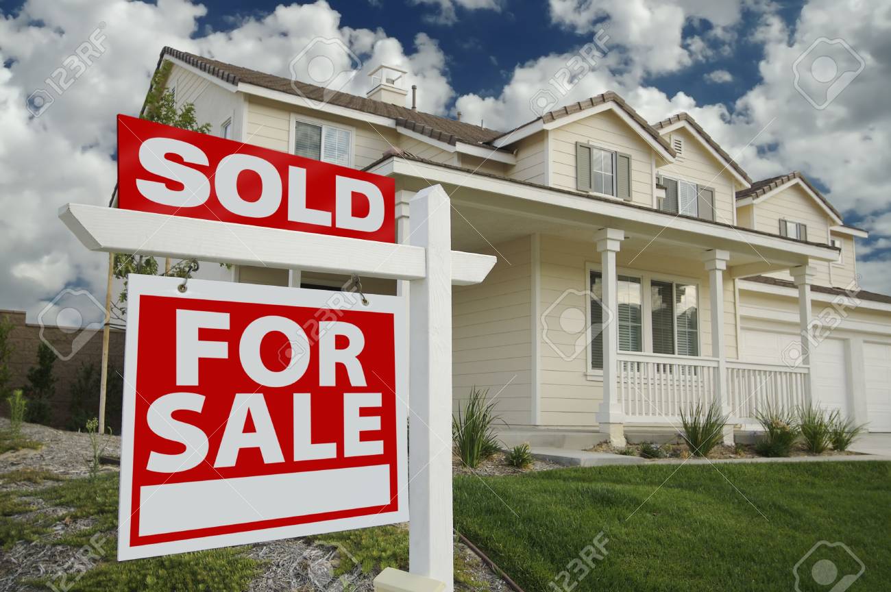 Sold Home For Sale Sign In Front Of Beautiful New Home Stock Photo