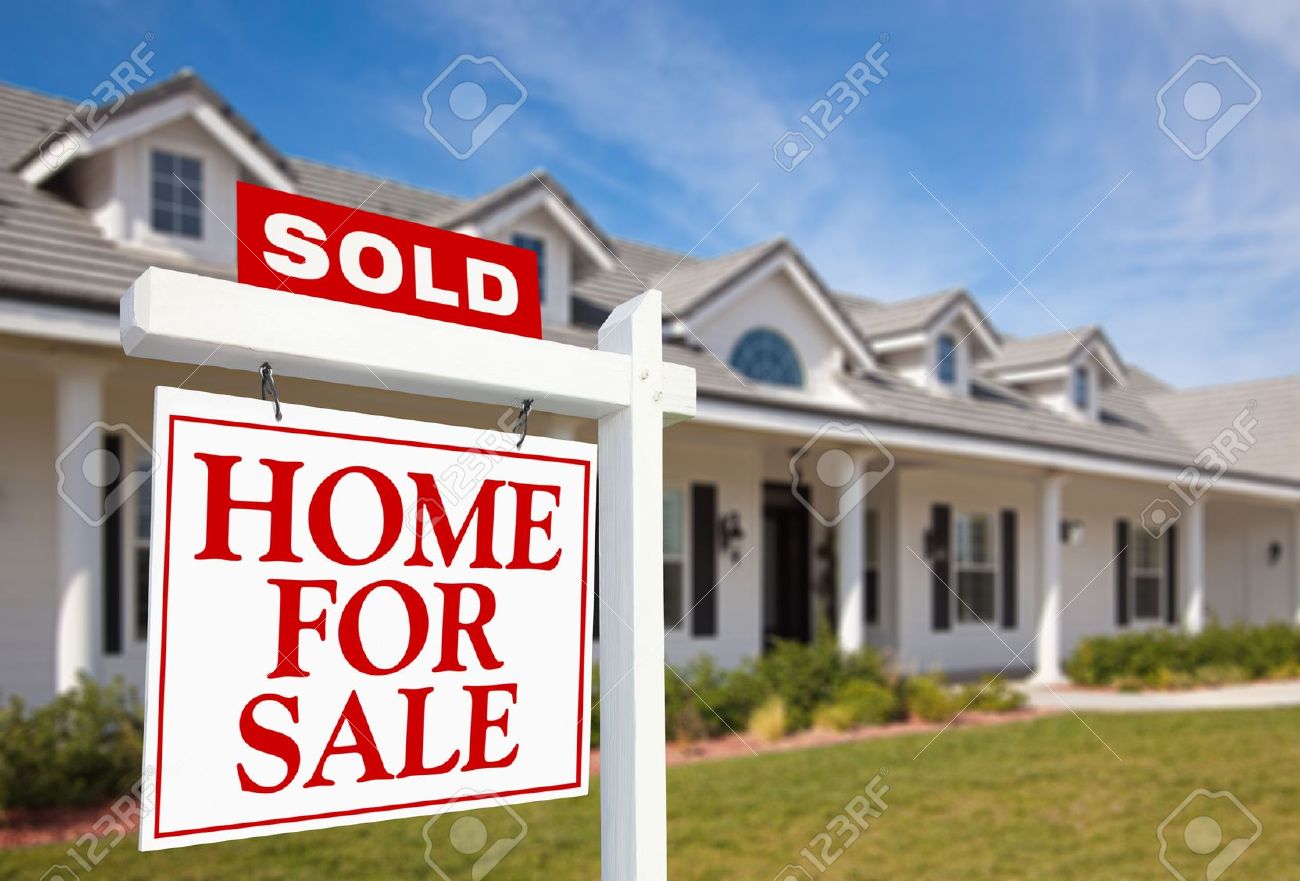 sold home for sale sign in front of beautiful new home for sale sign sold