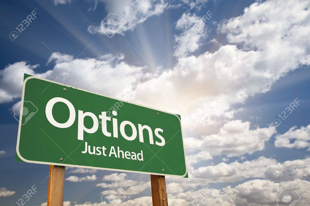 Options Green Road Sign Against Clouds and Sunburst. - 9812578 Options Green Road Sign Against Clouds and Sunburst. - 9812578