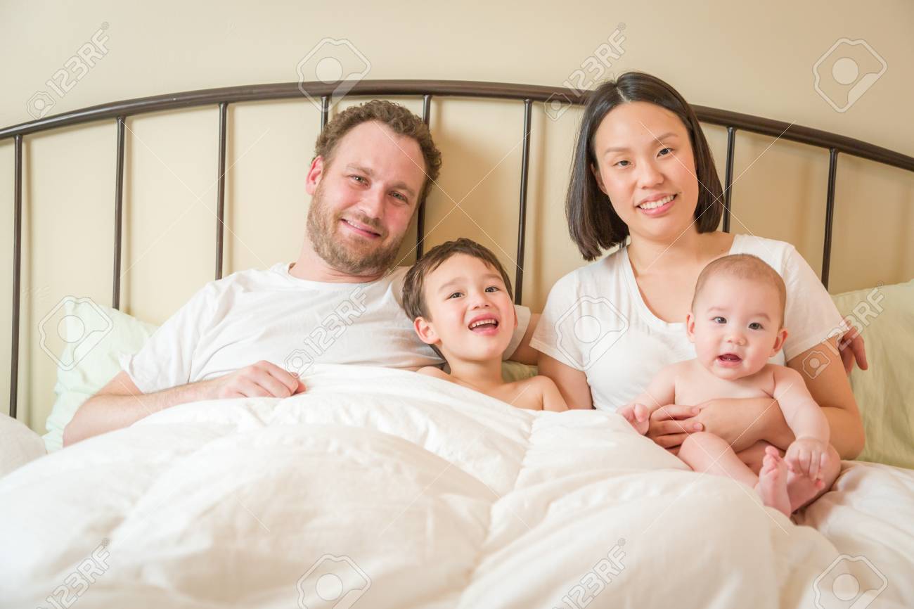 Young Mixed Race Chinese And Caucasian Baby Boys Laying In Bed With Their Father And Mother Stock Photo Picture And Royalty Free Image Image