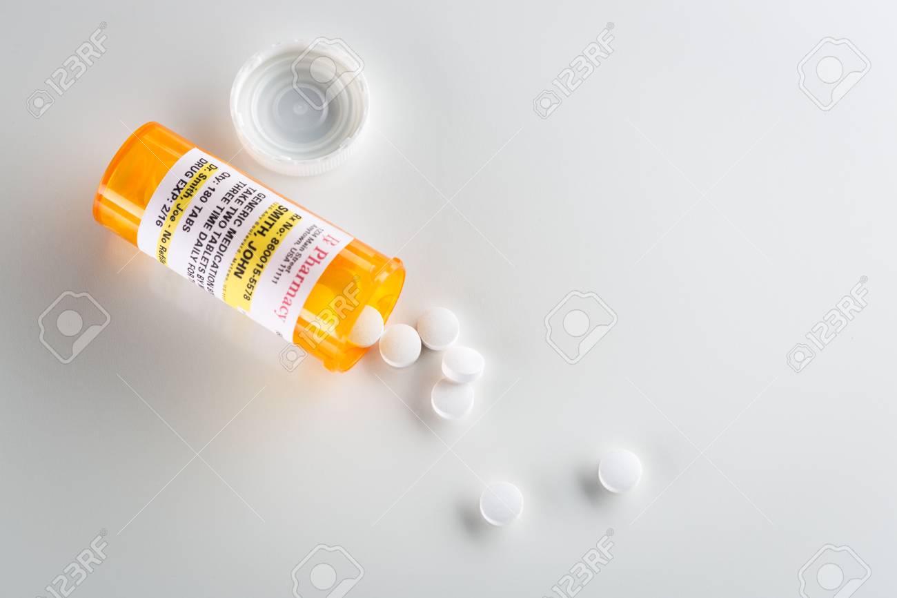 non proprietary medicine prescription bottle and spilled pills