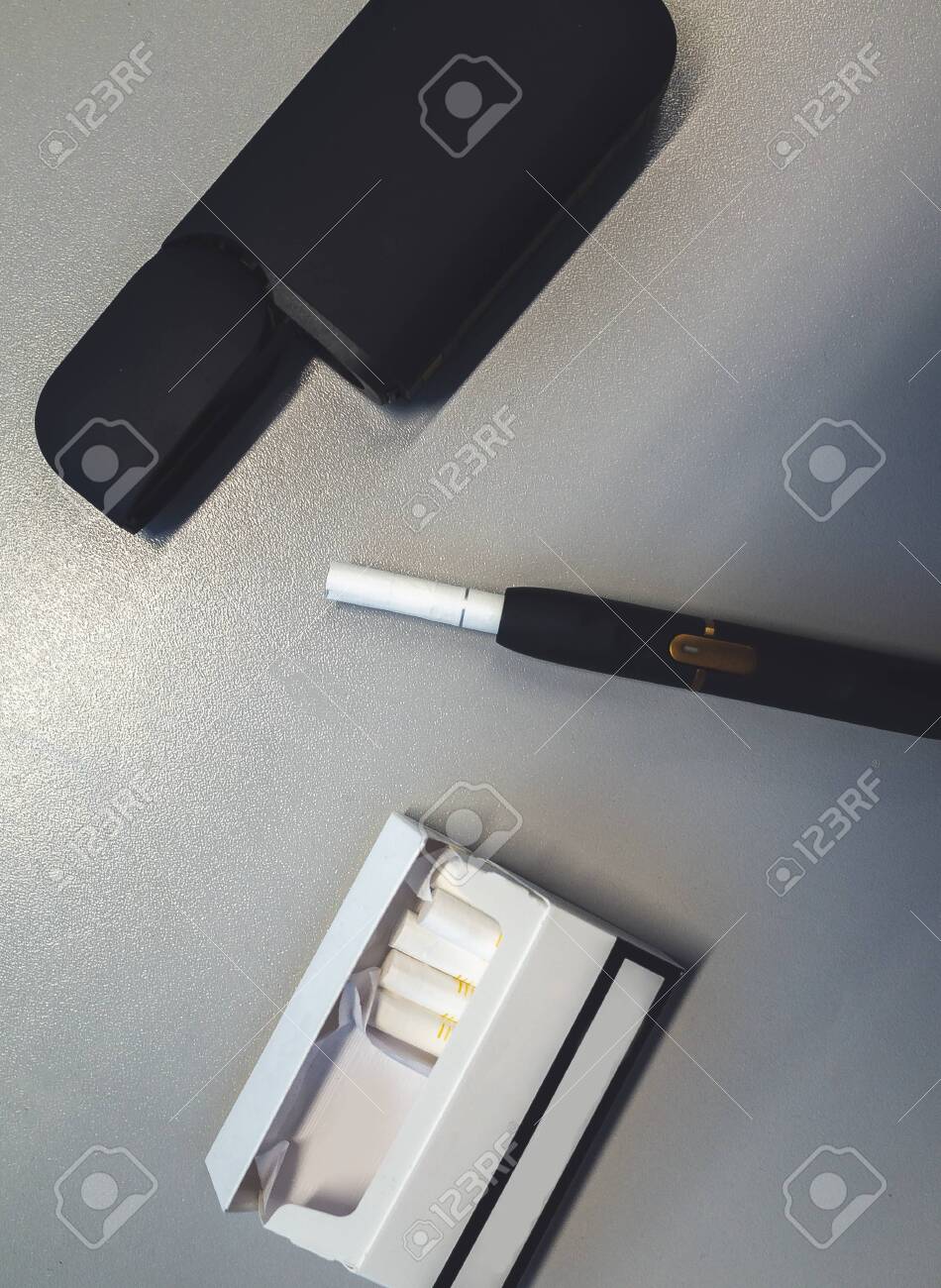 Download Tobacco Heating System And A Pack Of Tobacco Sticks On A Gray Stock Photo Picture And Royalty Free Image Image 123656258