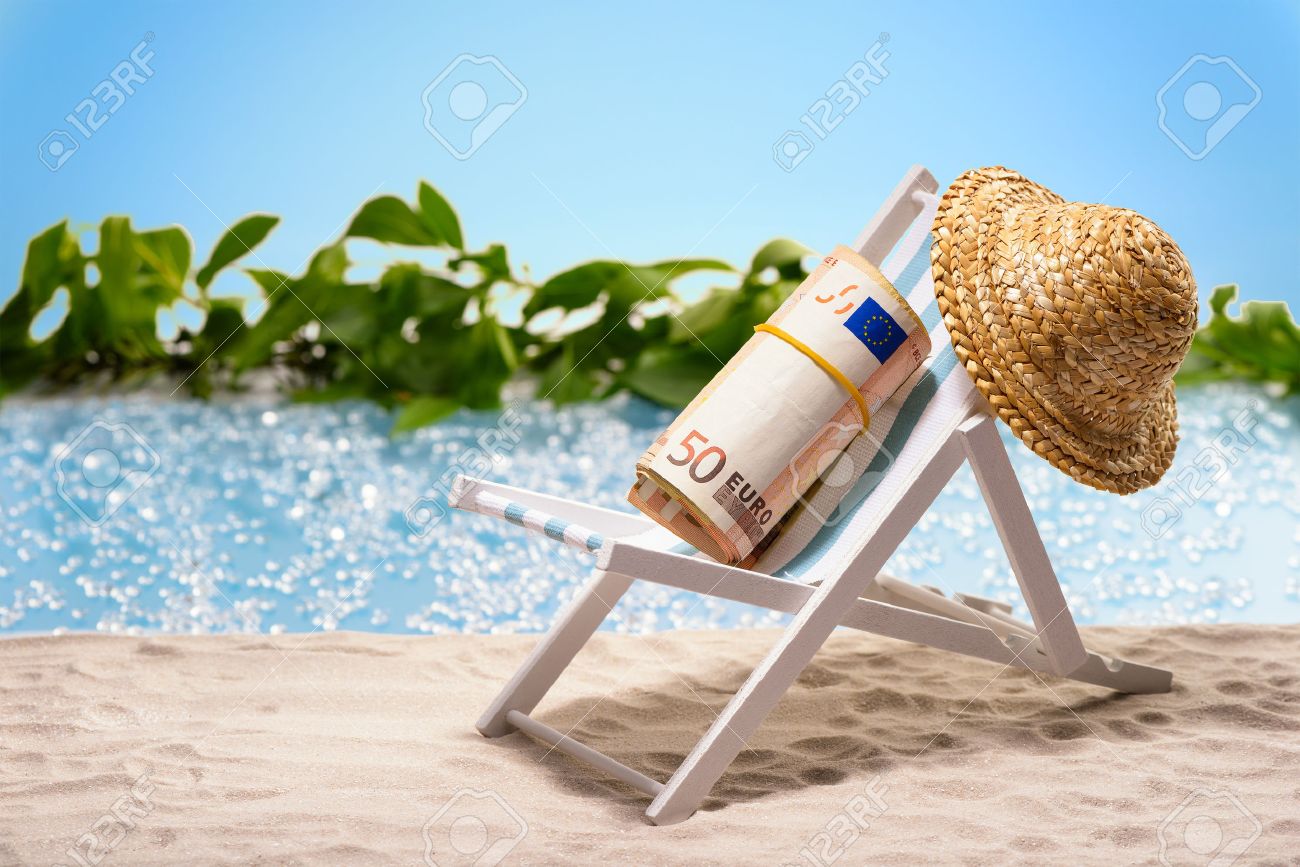 money on vacation pack of 50 euro bills sitting at the beach stock vacation pack