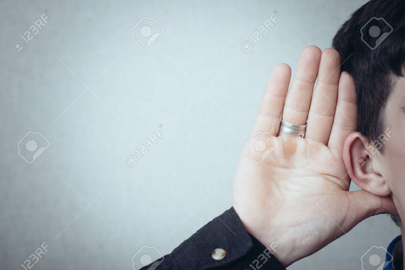 A man with his hand near his ear. Gesture can not hear without listening, talking louder. On a gray background - 42327303 A man with his hand near his ear. Gesture can not hear without listening, talking louder. On a gray background - 42327303
