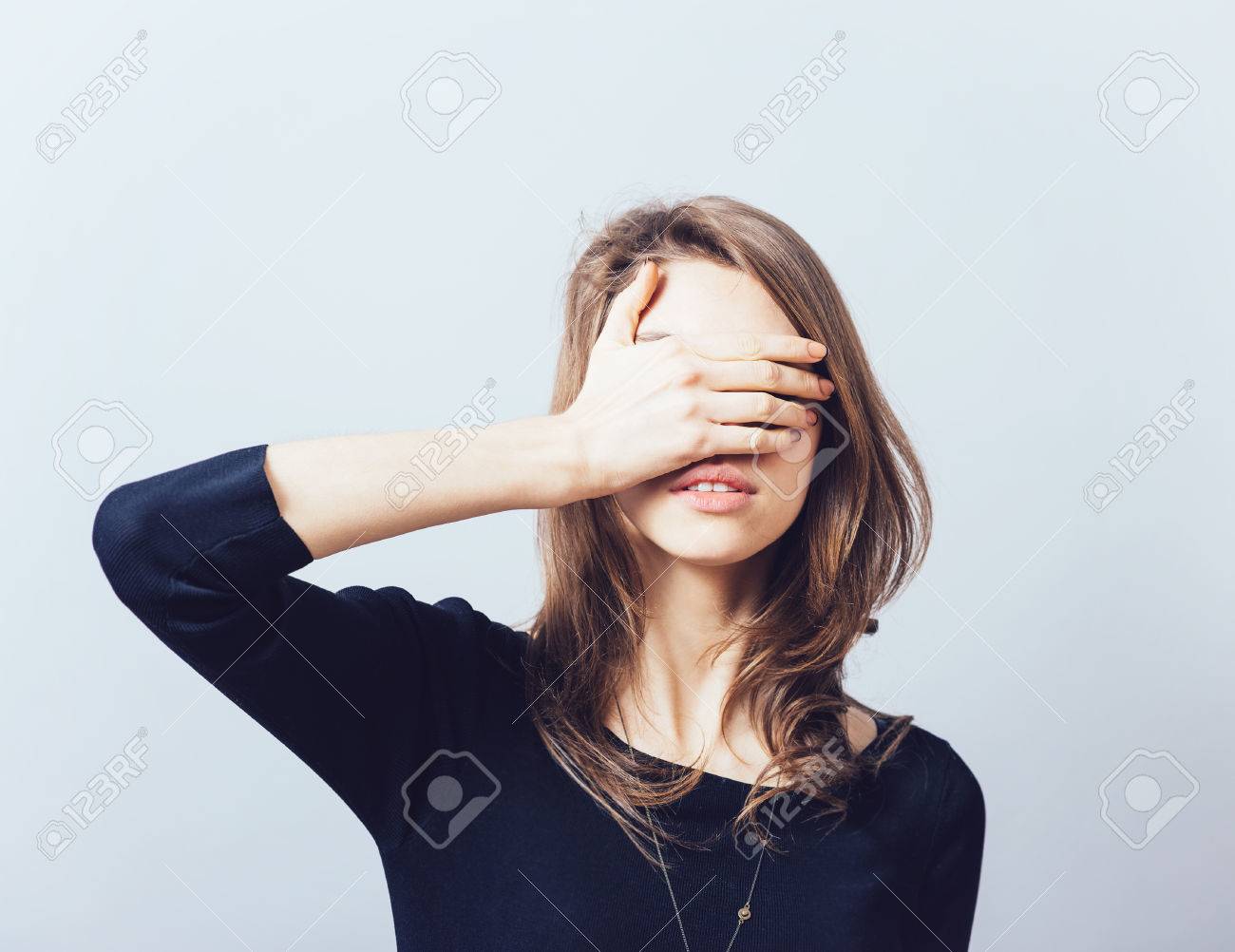 woman covering her eyes isolated on a gray background - 43142119 woman covering her eyes isolated on a gray background - 43142119