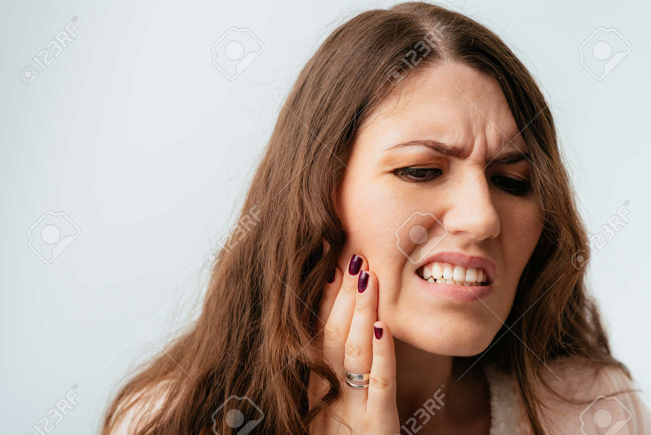 long-haired beautiful brunette girls have a toothache - 144789921 long-haired beautiful brunette girls have a toothache - 144789921
