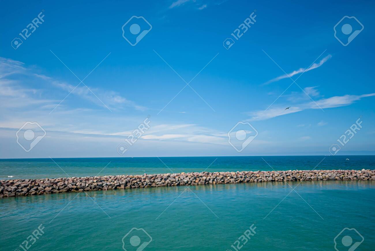Breakwater with calm waters on the inside and rougher seas outside. - 132316110 Breakwater with calm waters on the inside and rougher seas outside. - 132316110