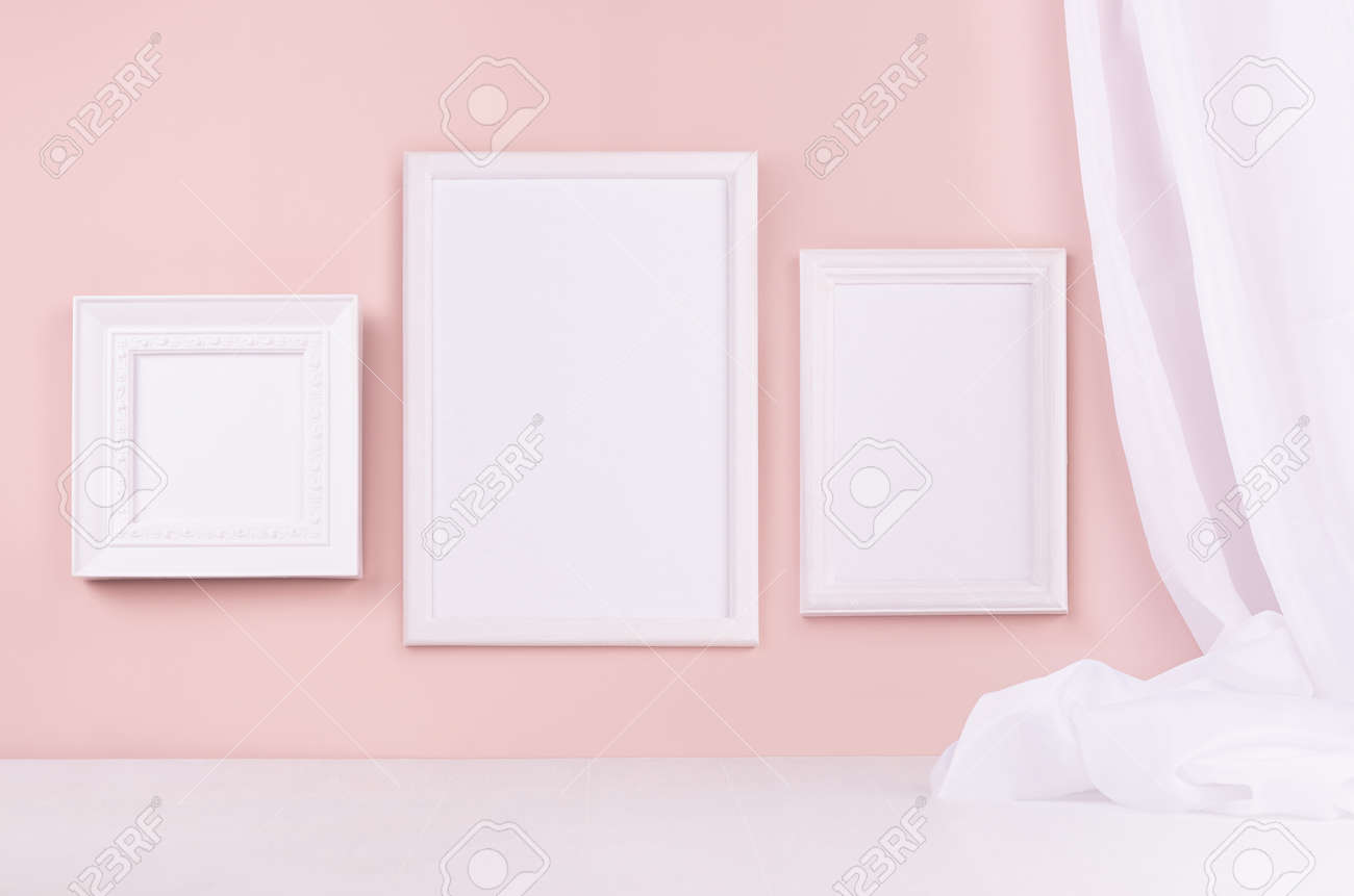 Minimal elegant gallery for display portfolio - three blank rectangle photo frames with flow silk curtain hanging on pink wall and white wood table. - 168468816 Minimal elegant gallery for display portfolio - three blank rectangle photo frames with flow silk curtain hanging on pink wall and white wood table. - 168468816