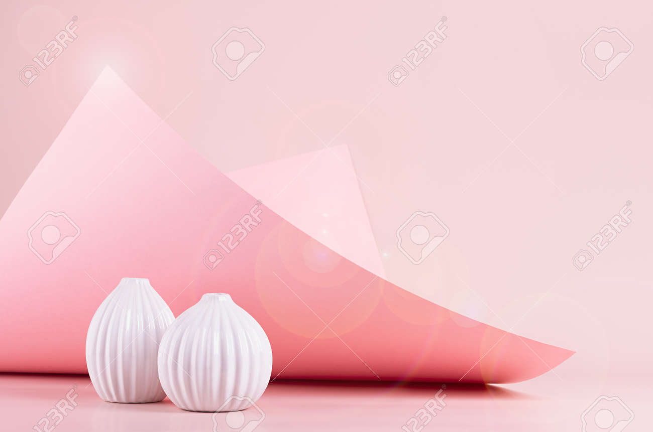 Bright spring fresh pink interior with white ceramic vases in sunlight with flares, hovering bend paper, glowing peak. Elegant geometric background. - 168468850 Bright spring fresh pink interior with white ceramic vases in sunlight with flares, hovering bend paper, glowing peak. Elegant geometric background. - 168468850