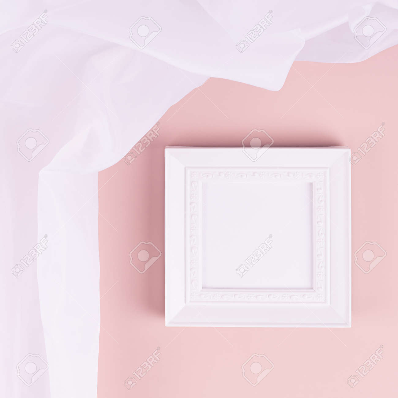 Abstract pastel pink interior with white blank square photo frame for text, design, poster, pictures with flow silk curtain on pastel pink wall. Mock up for display portfolio. - 168468868 Abstract pastel pink interior with white blank square photo frame for text, design, poster, pictures with flow silk curtain on pastel pink wall. Mock up for display portfolio. - 168468868