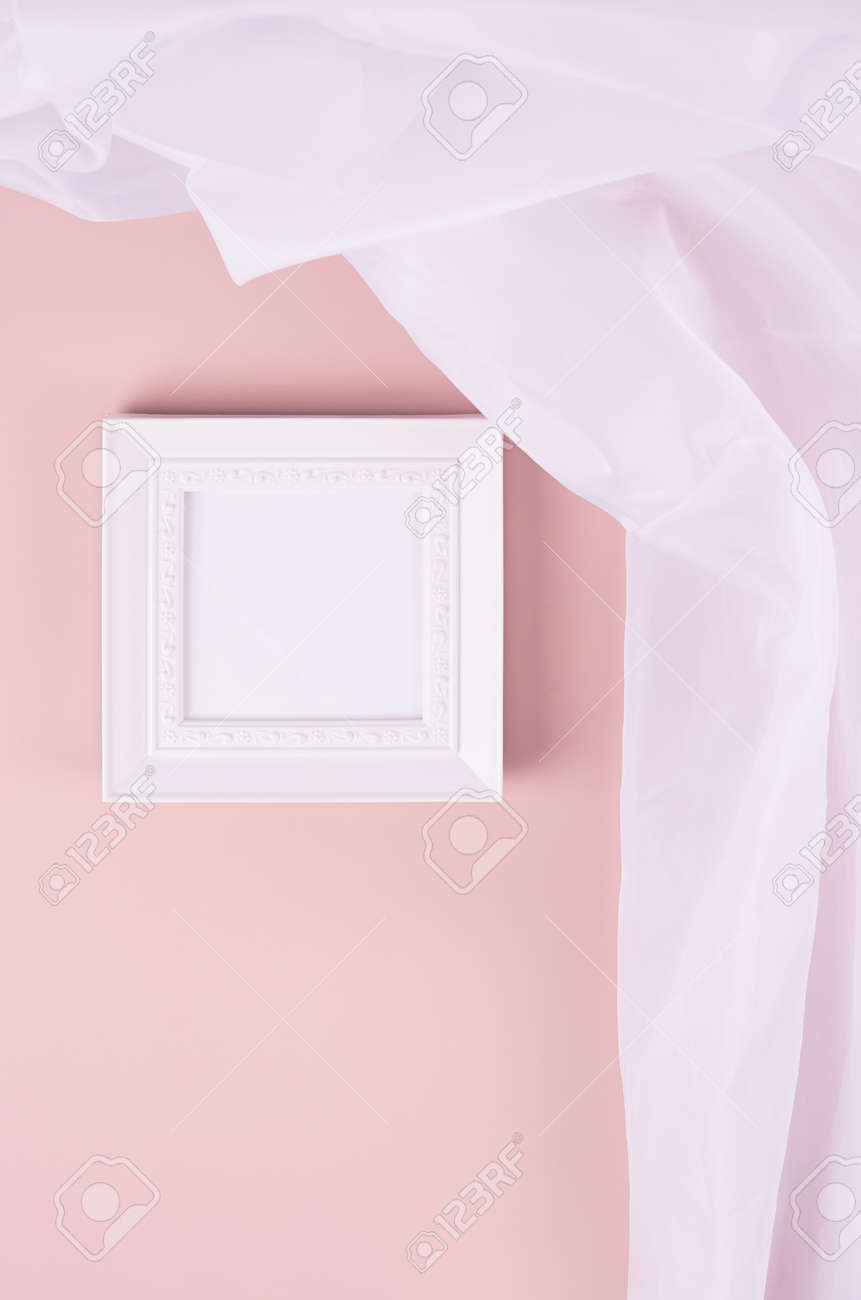 Minimal elegant gallery for display portfolio - blank square photo frame with flow silk curtain hanging on pink wall, vertical. - 168468925 Minimal elegant gallery for display portfolio - blank square photo frame with flow silk curtain hanging on pink wall, vertical. - 168468925