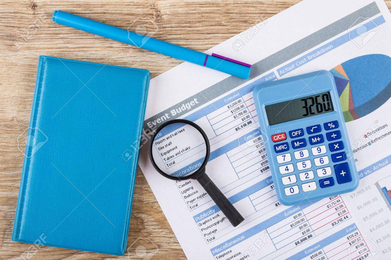 printout of event budget calculator notepad pen and magnifying event budget calculator