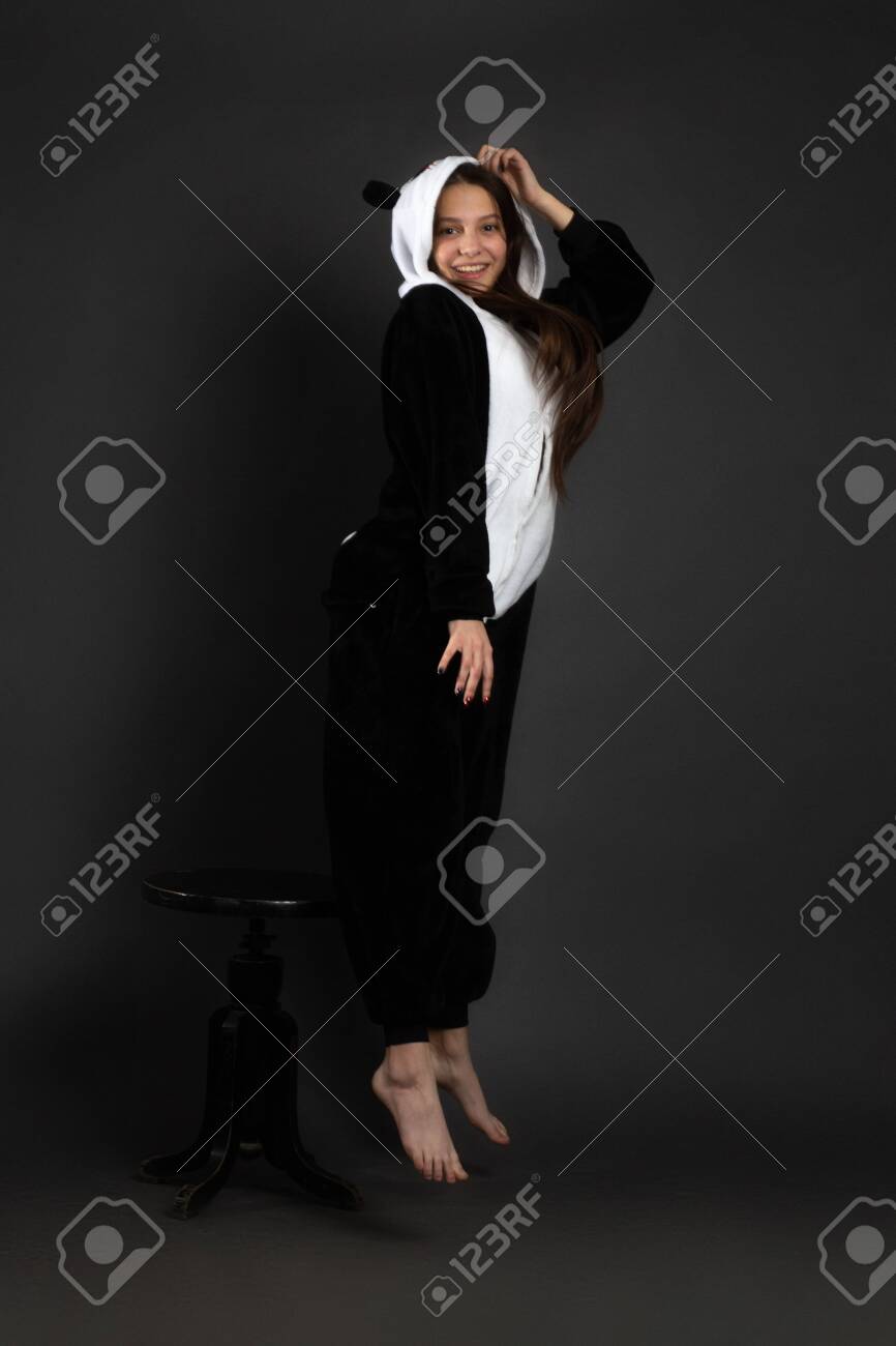 A Portrait Of Growth Of A Brunette Girl In The Studio On A Plain