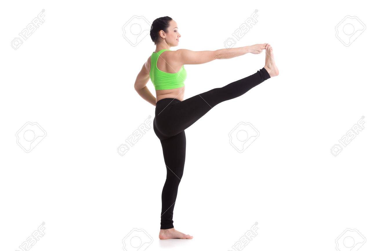 Sporty Girl On White Background Standing In Yoga Position Utthita Hasta Padangushthasana Extended Hand To Sporty Girl On White Background Standing In Yoga Position Utthita Hasta Padangushthasana Extended Hand To