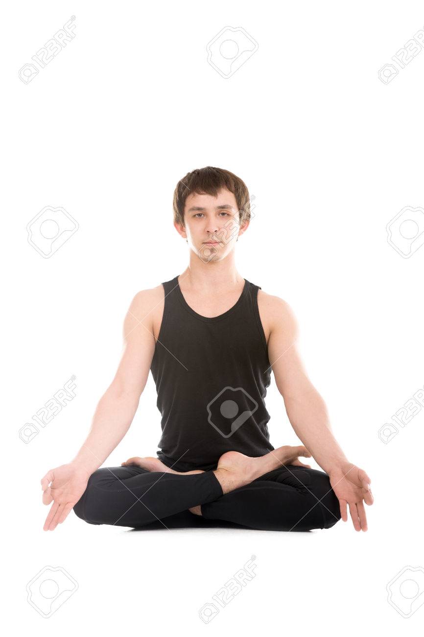 Vertical shot of relaxed young women sit crossed legs in lotus pose dressed  in activewear reach Stock Photo by wayhomestudioo