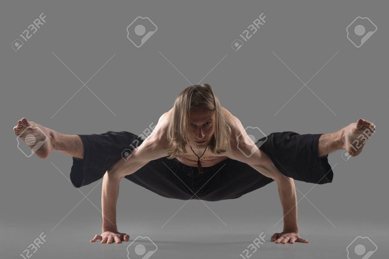 Sporty Young Man In Black Pants Doing Strengthening Yoga Pose Standing In Arm Balance Variation Of Firefly Posture Asana Tittibhasana Studio Shot On Gray Background Full Length Stock Photo Picture And Royalty