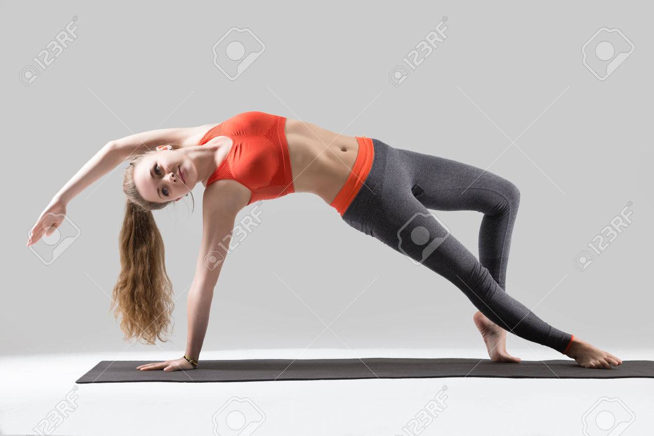 Young yogi attractive woman practicing yoga, doing Wild Thing,.. Young yogi attractive woman practicing yoga, doing Wild Thing,..