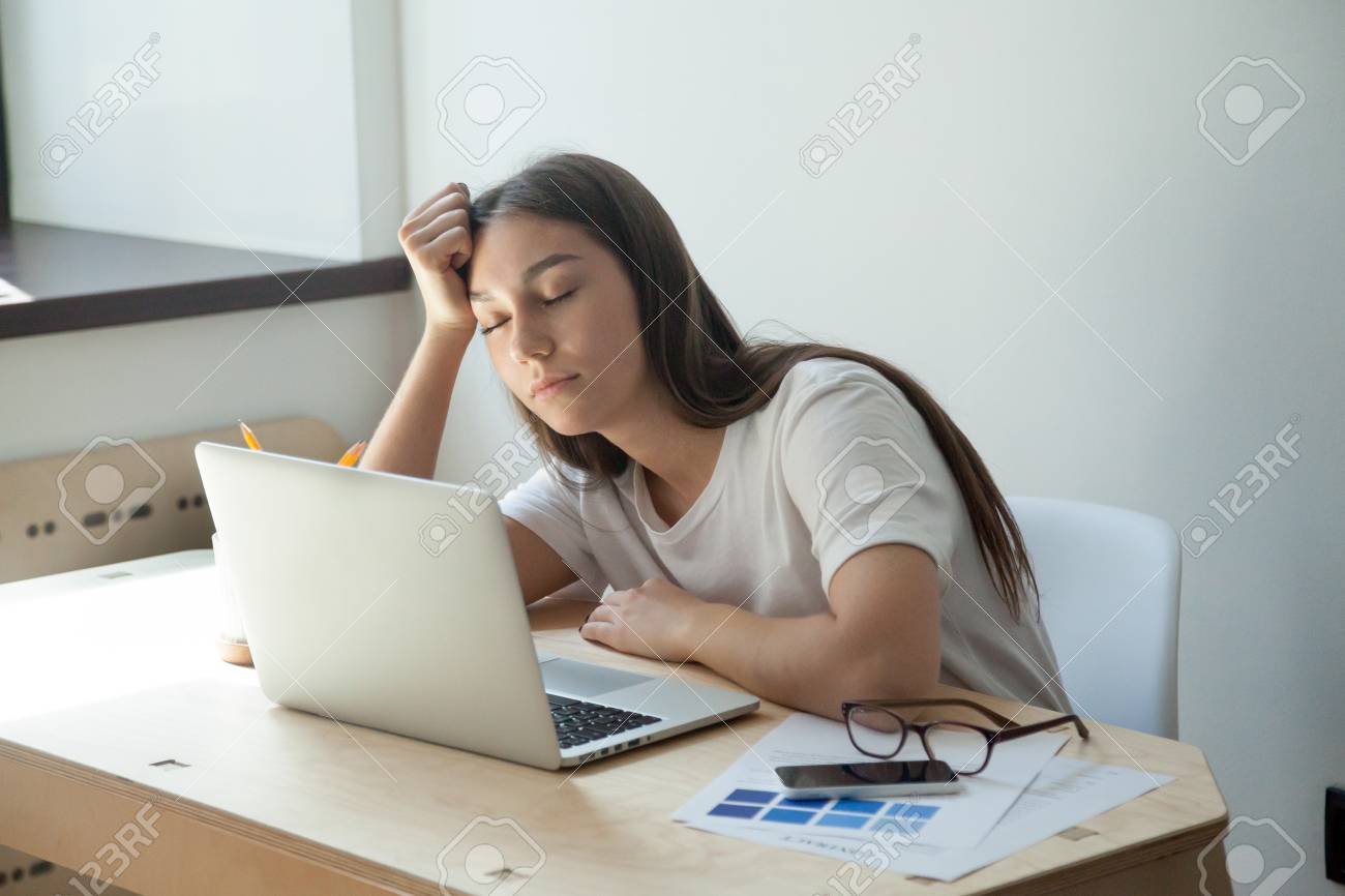 Young Adult Female Designer Sleeping On Her Desk, Near Her Laptop Computer  And Smartphone. She Just Finished Color Scheme For House Interior  Renovation Project And Waits For Customer Review. Stock Photo, Picture, image size:1300x866